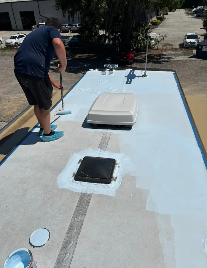 RV lap sealant application in Fort Lauderdale Florida - certified technician applying Dicor self-leveling roof sealant around AC unit and vent penetrations