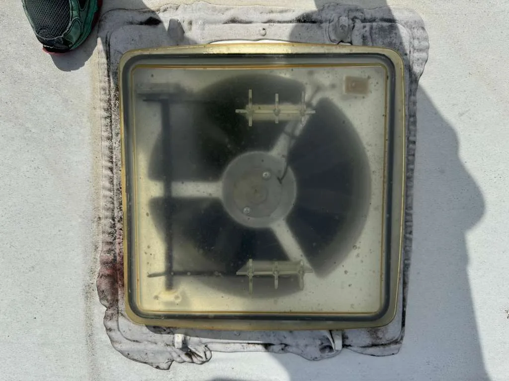 RV roof vent fan repair and Maxxair vent replacement in Fort Lauderdale FL - certified technician repairing 12V powered vent fan at Broward County campsite
